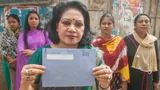 Indian women, one of them holds a tax envelope.