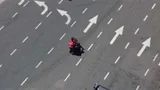 Food delivery guy seen from above on an empty road during quarantine.