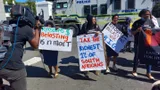 People in South Africa with signs protesting for wealth tax.