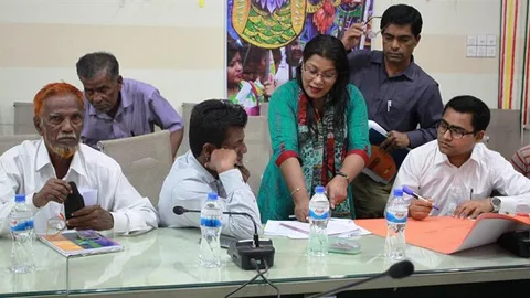 People sitting at a desk and talking.