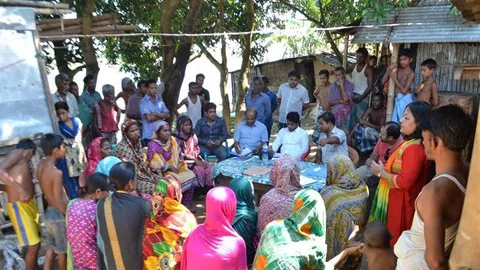 A group of people sitting around a table.