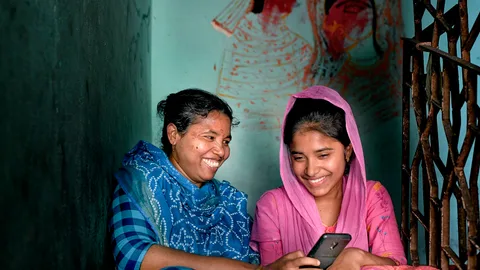 Photograph of two women looking at a phone
