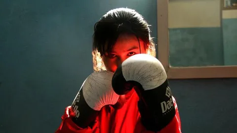 A woman wearing boxing gloves.