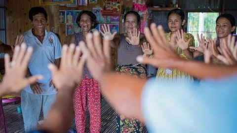 People holding their hands up and forward.