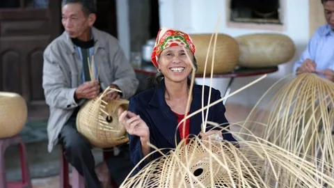 A woman and a man weaving baskets.
