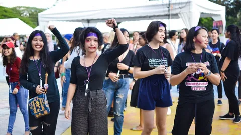 Foto van een groep vrouwen die hun arm omhoog houden met gebalde vuist