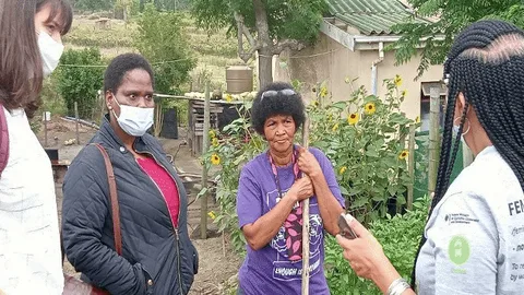 A group of women talking to each other.
