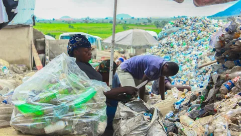 Two women sorting waste at Chanja Datti.