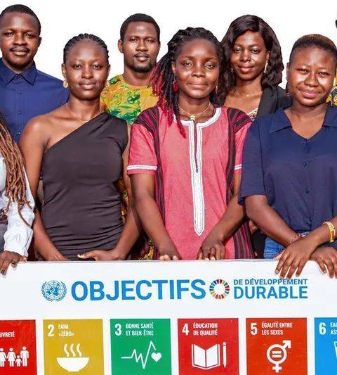 Young people from Burkina Faso with a sign about the SDG's.