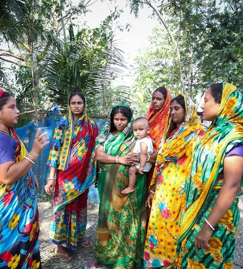 A group of women wearing colorful dresses.