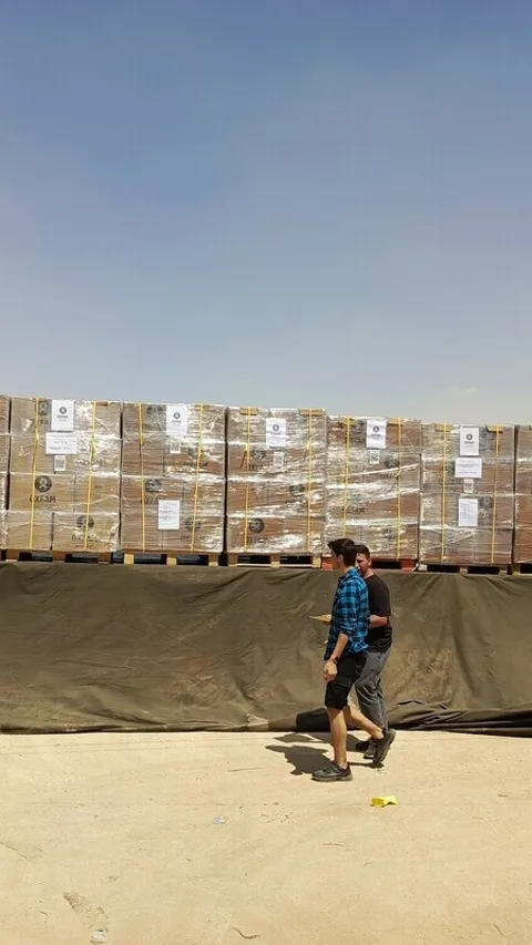 Oxfam loading and packing a shipment of dry food parcels that will be part of the food trucking entering Gaza.