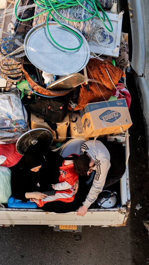 A family carrying their belongings in a pickup truck is stuck in heavy traffic caused by mass displacement for the second consecutive day from southern Lebanon toward Beirut, in Khaldeh at the southern entrance of the capital, Beirut, Lebanon, March 3, 2026.